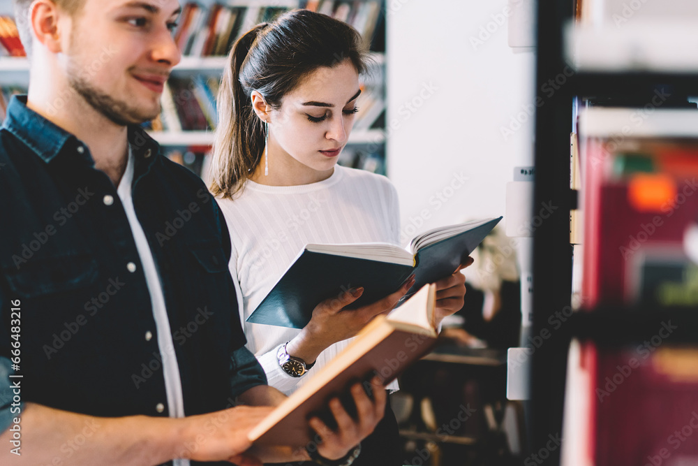 Happy man reading book in library