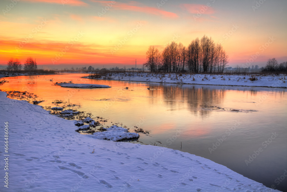 Winter landscape, amazing sundown in winter , Poland Europe, river valley Knyszyn Primeval Forest