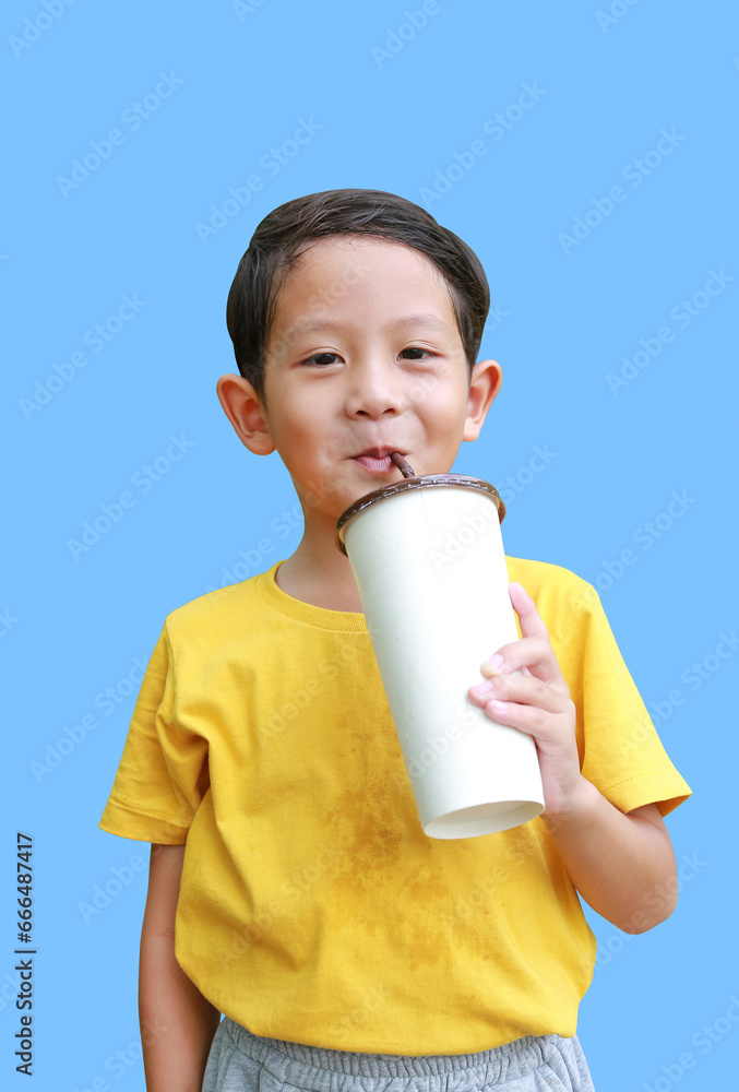 Happy Asian little boy kid with sweating holding paper cup and drinking