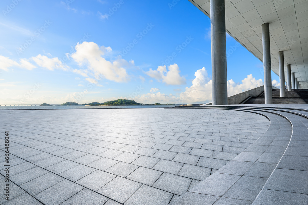 Empty square platform and coastline scenery under blue sky