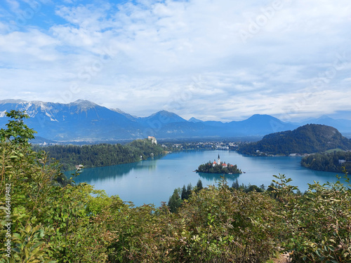 lake Bled and dark blue mountains under white clouds. Slovenia.