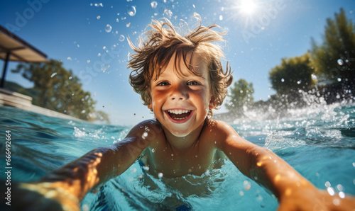 Happy child enjoying fun in the pool. Happy childhood and have a great summer. © Bartek