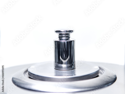 Obraz na plátně Close-up of metal weight to calibrate on a balance in a laboratory