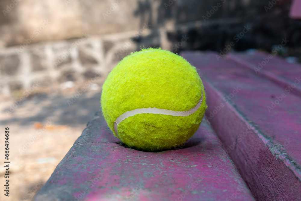 Tennis ball on the wooden background