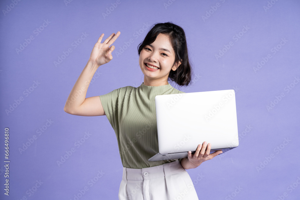 Portrait of beautiful asian woman posing on purple background Portrait of beautiful asian woman posing on purple background
