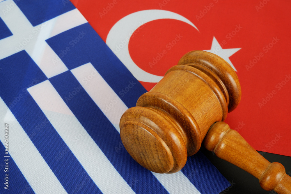 Conflict between Greece and Turkey concept. Gavel on flags of Turkey and Greece.	