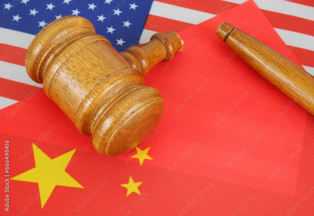 Trade tension or trade war between USA and China, financial concept. Economy conflict, US tariffs on exports, trade frictions. Broken gavel and flags of US and China.