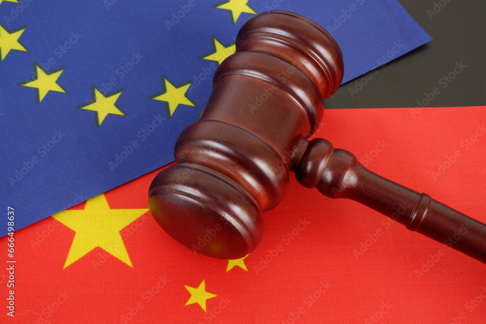 China and European Union collaboration concept. Wooden gavel and flags of EU and China.