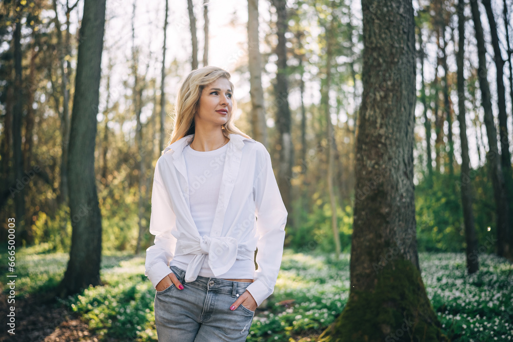Portrait of young woman walking in spring forest. Portrait of young woman walking in spring forest.