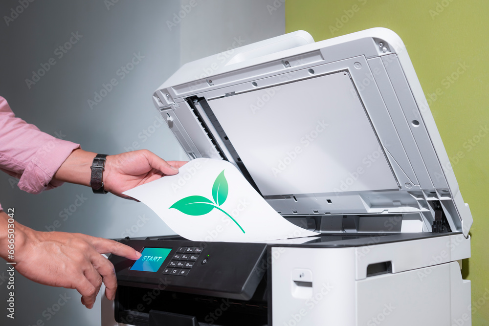 office worker prints paper on a multifunction laser printer with