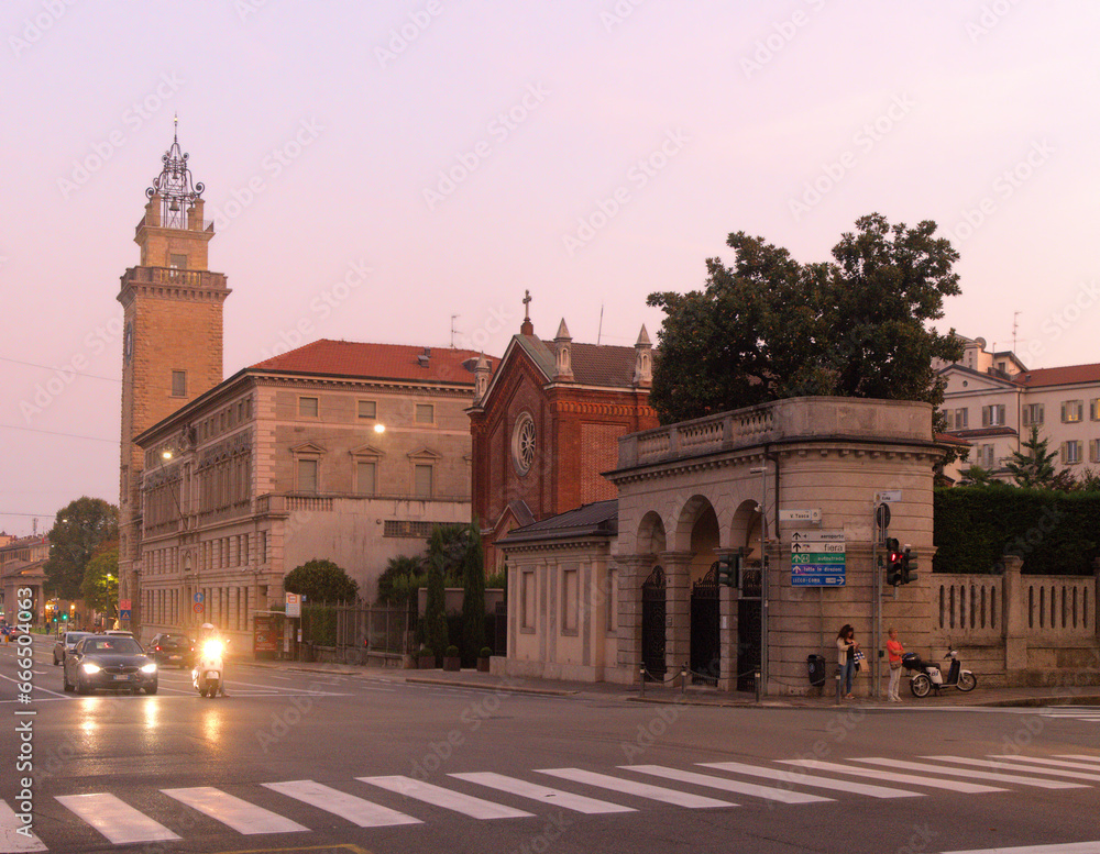Bergamo street scene showing the Torre dei Caduti at dusk
