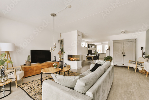 Living room with sofa and television placed by fireplace photo