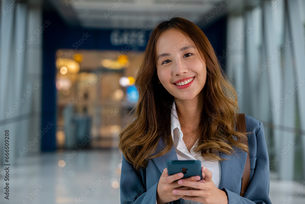 Beautiful lady holding a cell phone, typing an important work message on the go, outdoor summer city environment. Business lifestyle Beautiful lady holding a cell phone, typing an important work message on the go, outdoor summer city environment. Business lifestyle