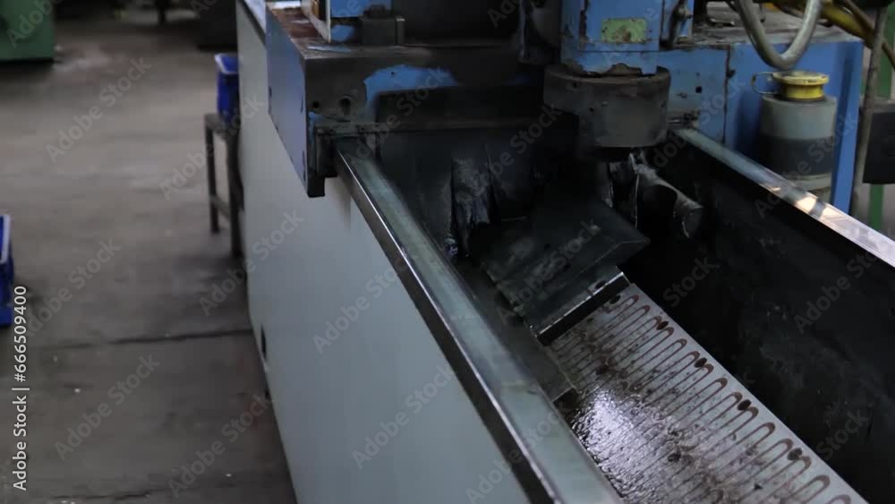 Machine Putting Oil on Metal Blade in Factory Machine Putting Oil on Metal Blade in Factory