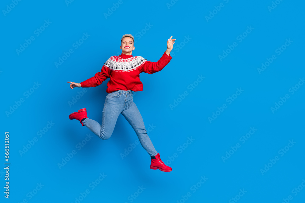 Full body length size photo of nice attractive positive woman wear red ornament sweater jump hurry shopping mall isolated on blue color background