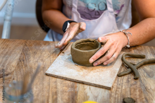 Ceramic Workshop. Middle aged woman working on her new ceramic creation