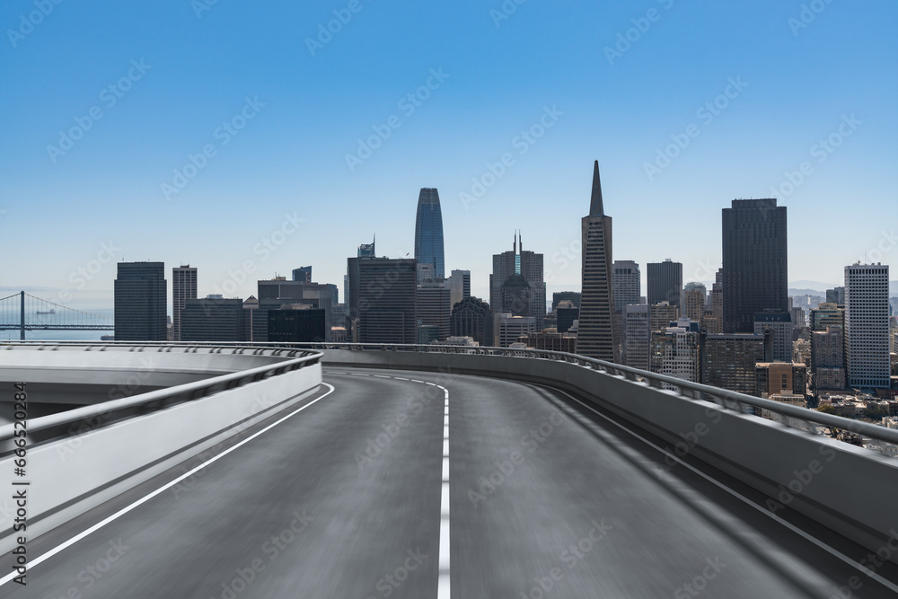 Empty urban asphalt road exterior with city buildings background. New modern highway concrete construction. Concept way to success. Transportation logistic industry fast delivery. San Francisco. USA. Empty urban asphalt road exterior with city buildings background. New modern highway concrete construction. Concept way to success. Transportation logistic industry fast delivery. San Francisco. USA.