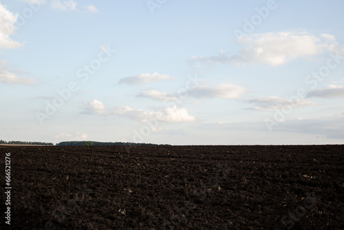 Landscape, field, black soil, soil texture. Plowed land. Agriculture.