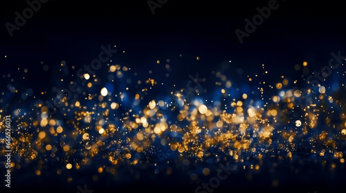 Abstract blue and gold shiny Christmas background with bokeh. Holiday bright blurred backdrop with particles.