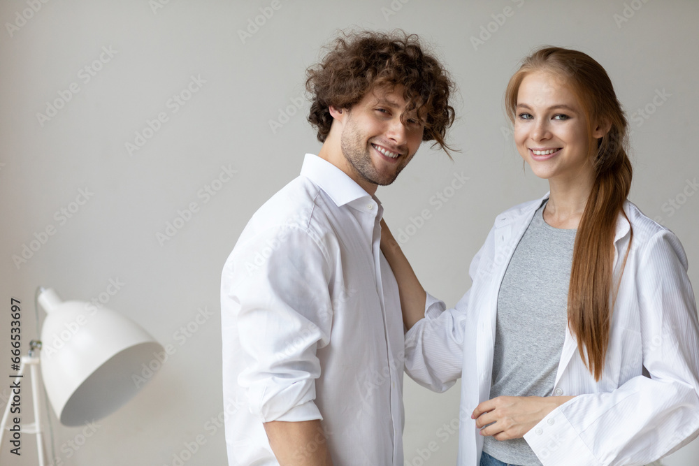 Young beautiful couple hugging, portrait of lovers at home, looking good, tender. Home family life. Young beautiful couple hugging, portrait of lovers at home, looking good, tender. Home family life.