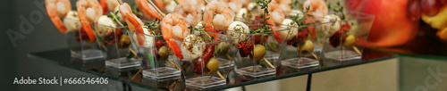 Food at event. Disposable plastic cups with snacks - shrimp with mozzarella cheese. Banner.