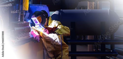 Man welder. Worker uses sol...
