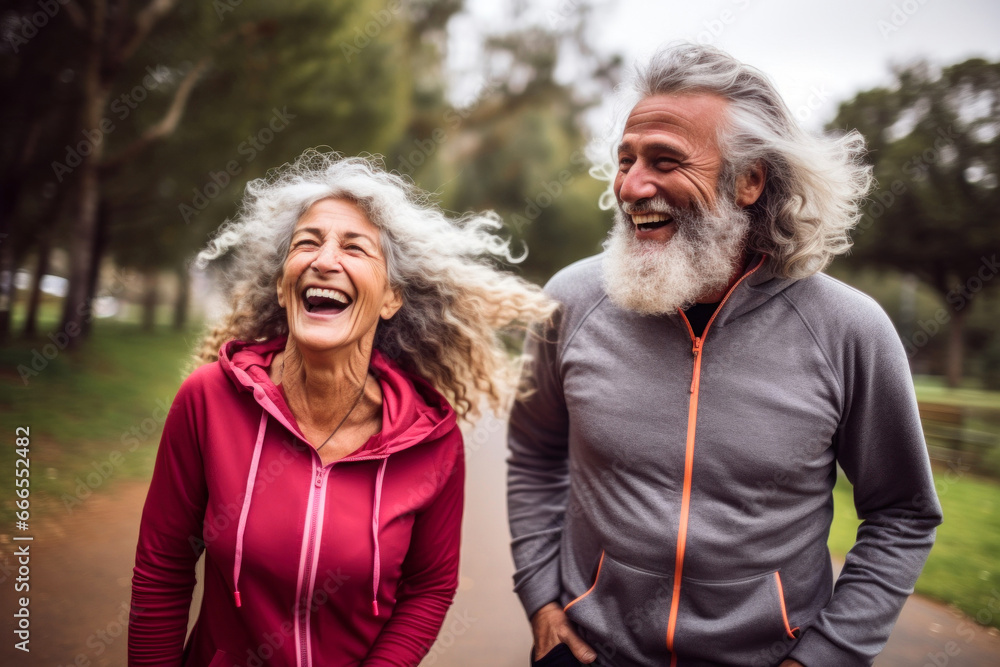 Laughing active senior couple in public park together having fun lifestyle Laughing active senior couple in public park together having fun lifestyle