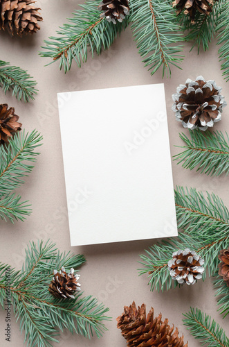Blank Christmas holiday greeting card mockup with fir tree branches with cones decor, white mock up with copy space