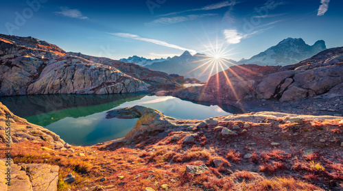 Sunny autumn scene of Lac Blanc lake with Mont Blanc (Monte Bianco) on background, Chamonix location. Astonishing morning view of Vallon de Berard Nature Preserve, Graian Alps, France, Europe. © Andrew Mayovskyy