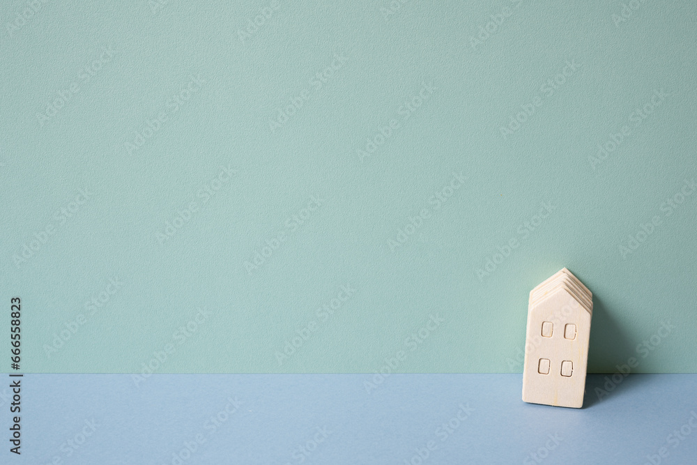 Miniature wood model house on mint blue background. rental, buy, real estate concept Miniature wood model house on mint blue background. rental, buy, real estate concept
