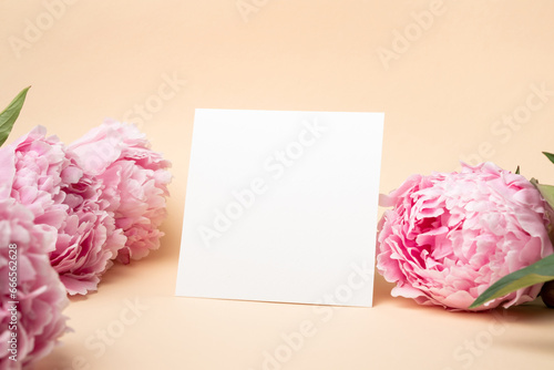 Square paper card mockup with pink peony flowers, blank invitation, greeting or flyer card mock up