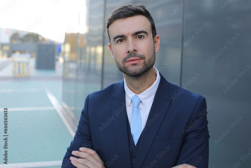 Powerful looking businessman crossing his arms Powerful looking businessman crossing his arms