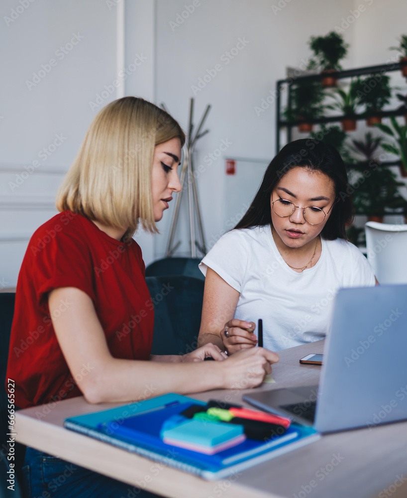Smart serous women working in creative workplace Smart serous women working in creative workplace