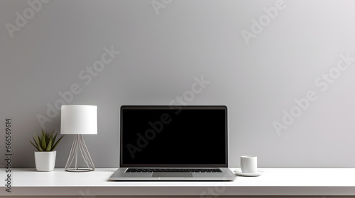 Laptop computer with blank screen on desk in modern home or office interior mock up © Oksana