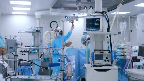 Professional surgeons prepare for heart surgery in a state-of-the-art surgery room. Nurses preparing equipment