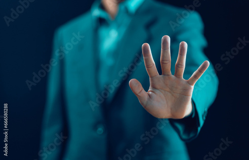 The man's hand showing palm gestures stop concept of refuse caution