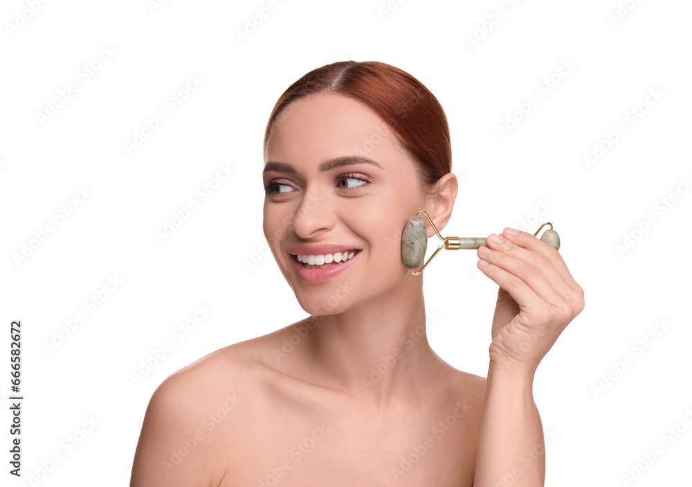 Fototapeta premium Young woman massaging her face with jade roller on white background