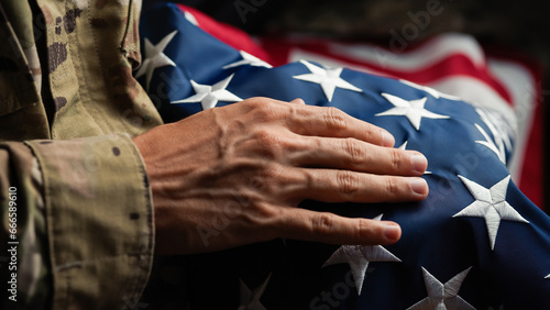 Schilderij op canvas USA soldier caressing a United states flag on veterans day