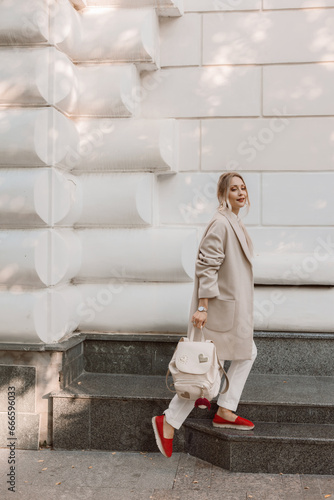 Fashion woman wearing beige coat on the street