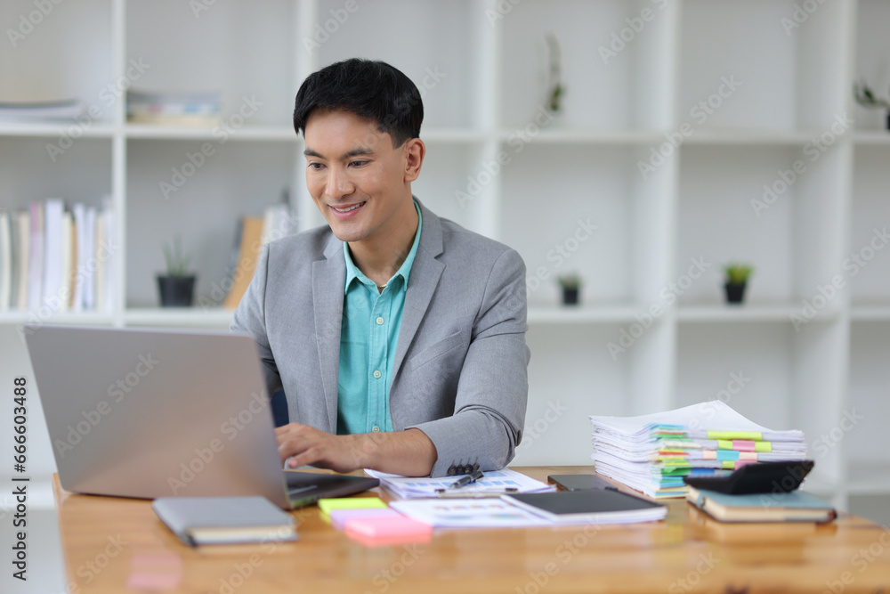 Businessman working on documents on a desk in a business office. Businessman working on documents on a desk in a business office.