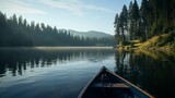 Peaceful morning on lake with canoe and pine trees