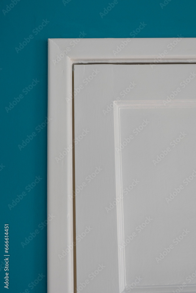 White Wooden Door against Teal Blue Wall White Wooden Door against Teal Blue Wall