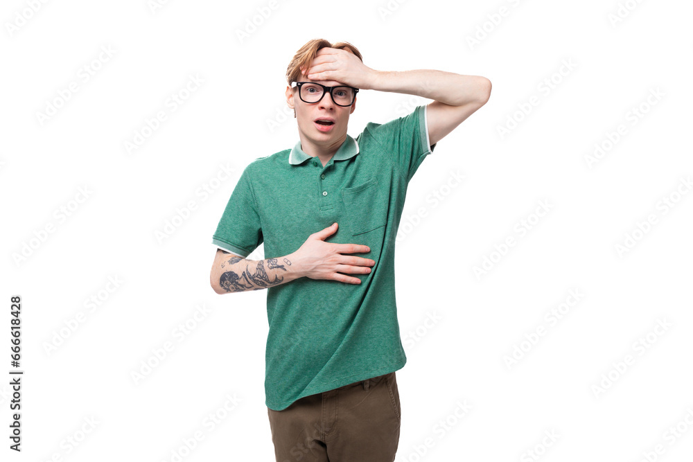 young european guy with red hair is shocked and puzzled on a white background with copy space young european guy with red hair is shocked and puzzled on a white background with copy space