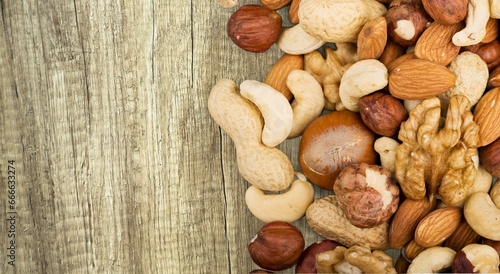 Mix of tasty dry nuts and fruits on the desk