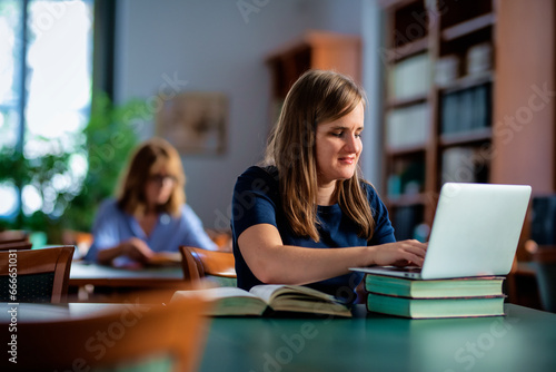 Wallpaper Mural A visually impaired woman sitting and studying in the university library Torontodigital.ca
