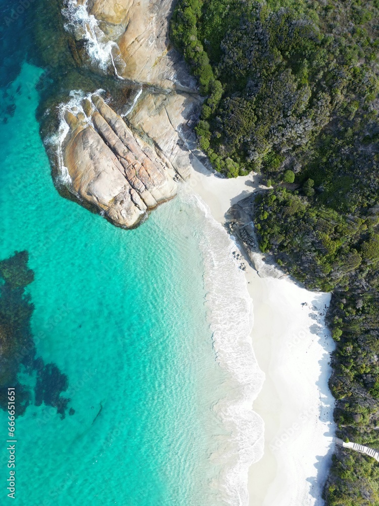 Aerial view of a tropical island with white sand beaches and crystal clear turquoise waters.