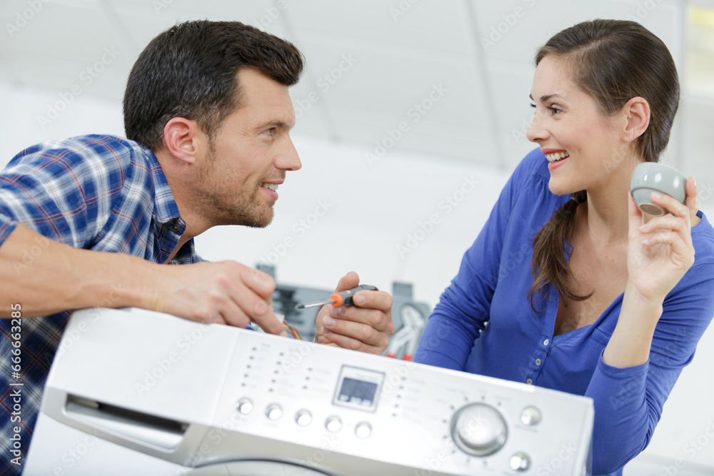 a washing machine repair service with female customer a washing machine repair service with female customer