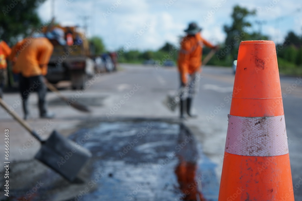 Blurry image of the excavation and repair work of the pavement with human labor. Blurry image of the excavation and repair work of the pavement with human labor.