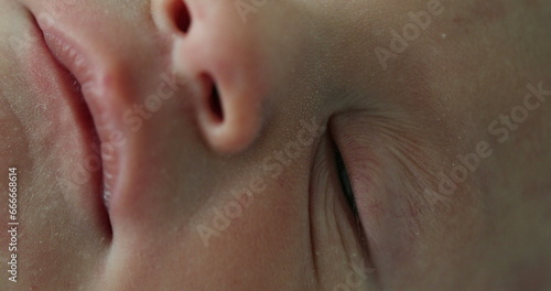 Macro close-up of newborn infant face in first day of life