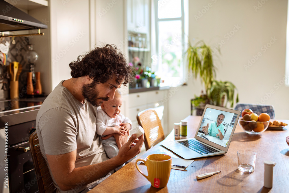 Young father consulting a doctor on a video call about medication for his baby Young father consulting a doctor on a video call about medication for his baby